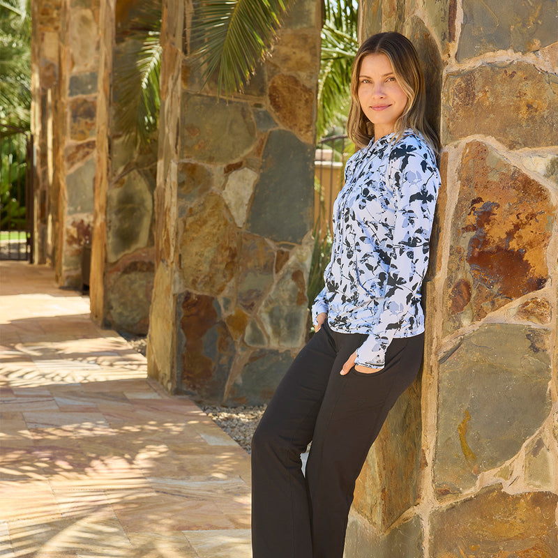 woman leaning on rock wall in pullover hoodie|shadow-ivy