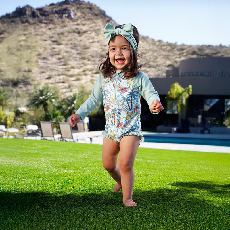 baby girl in long sleeve ruffled swim romper|retro-island