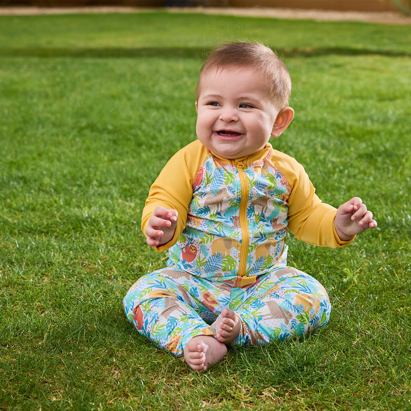 baby boy playing in grass in swim leggings|jungle-friends