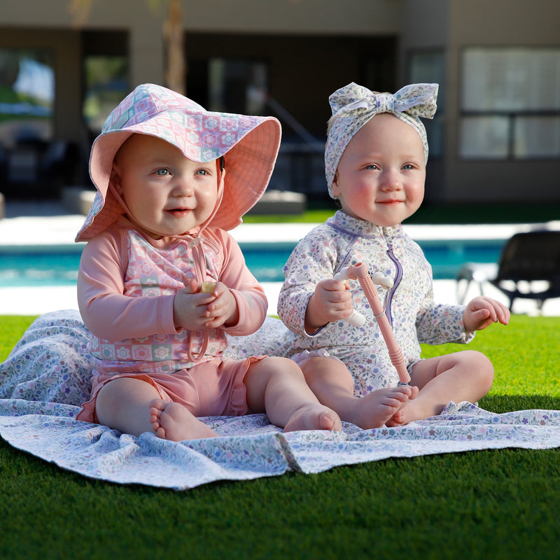 baby in long sleeve zippy sun and swim suit|tiled-flowers