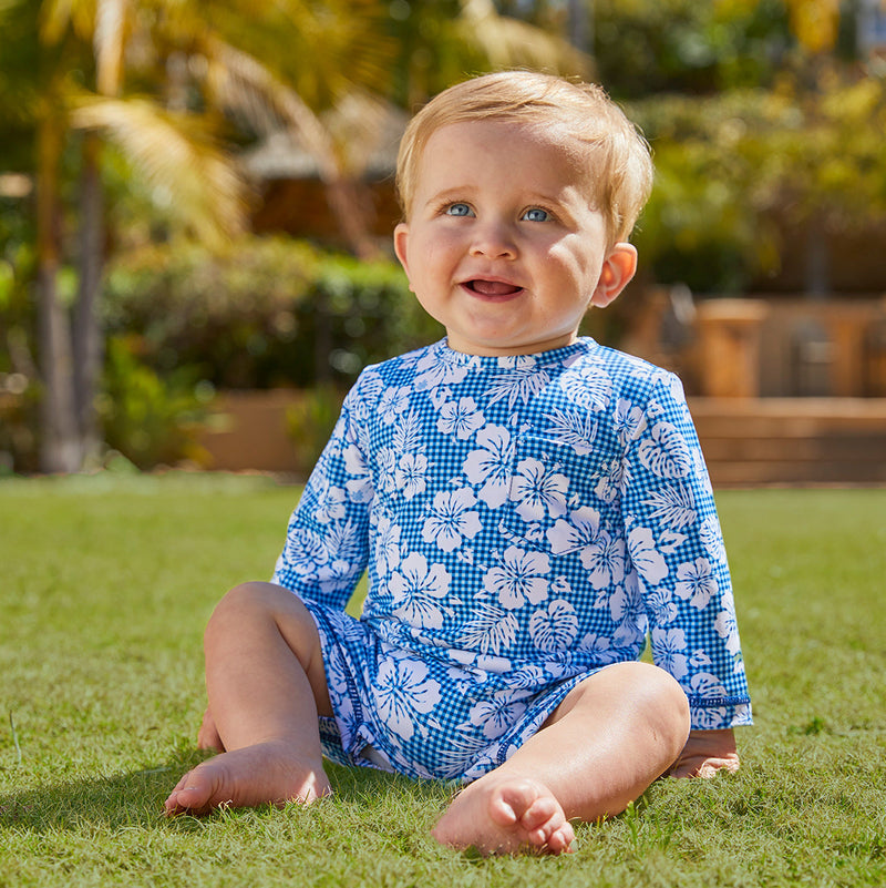 Little boy in UV Skinz's baby boy's UV onesie in blue hibiscus gingham|blue-hibiscus-gingham