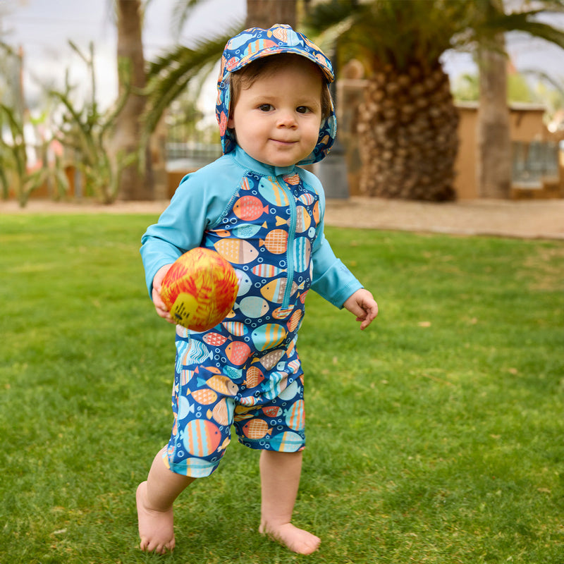 baby boy running in grass in long sleeve swim romper|fish-parade