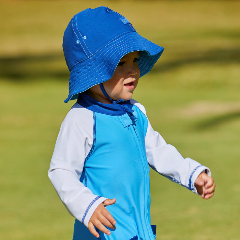 Little boy in UV Skinz's baby boy's sun hat in ocean blue navy|ocean-blue-navy