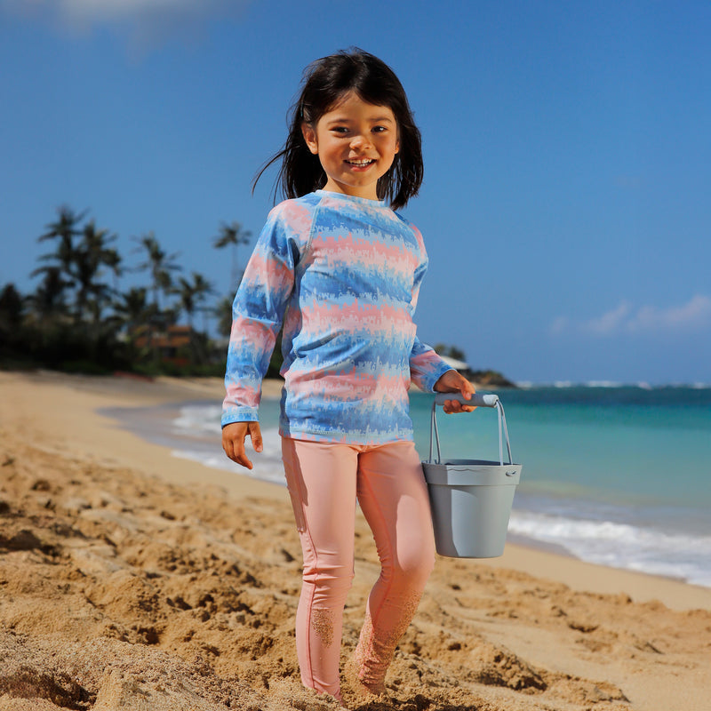 girl on the beach in long sleeve crew sunny swim shirt in sandcastle dreams|sandcastle-dreams