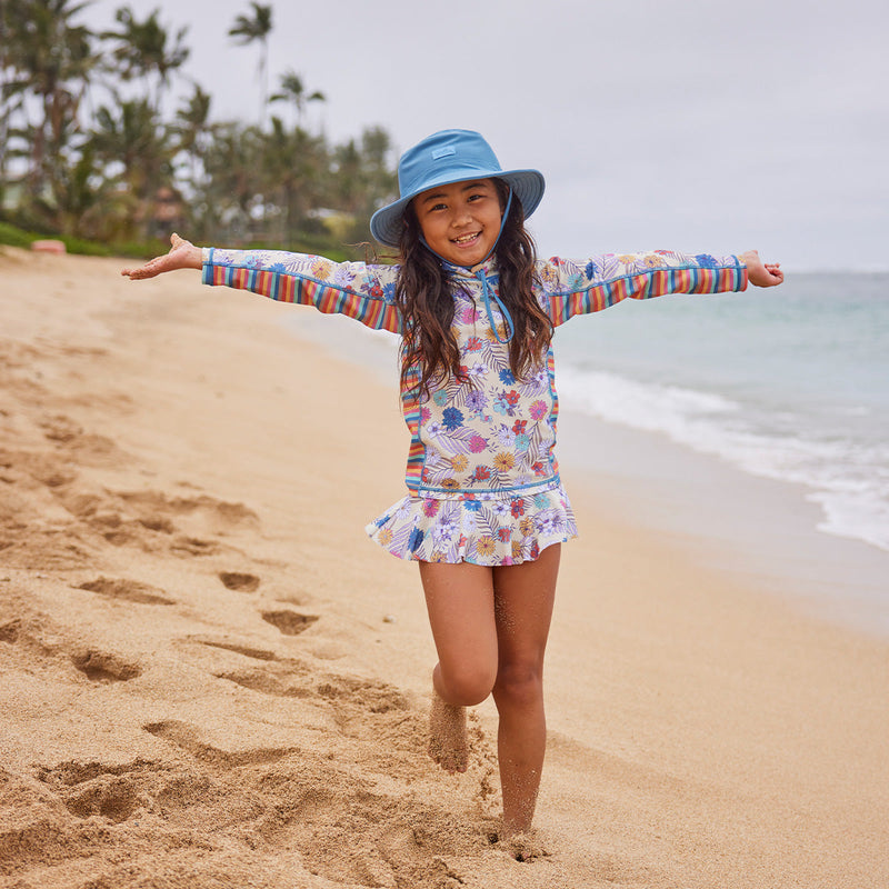 girl running on beach in swim hat|wild-rose