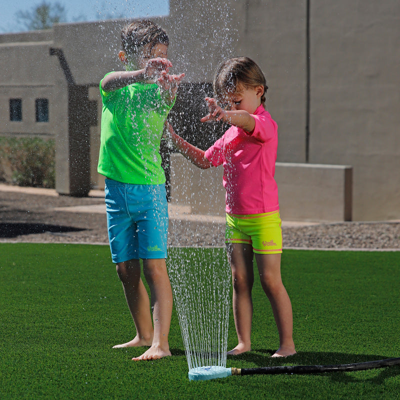 kids playing in the sprinklers wearing kids neon magic print sun and swim shirt|neon-sharks