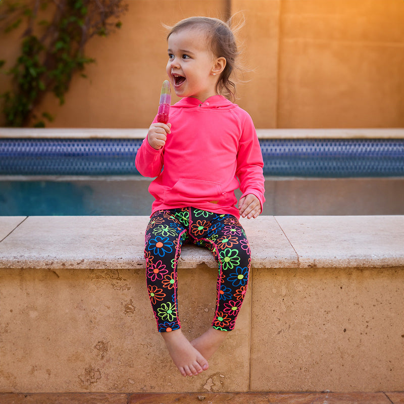 girl sitting by pool in active swim tights neon upf|neon-daisies