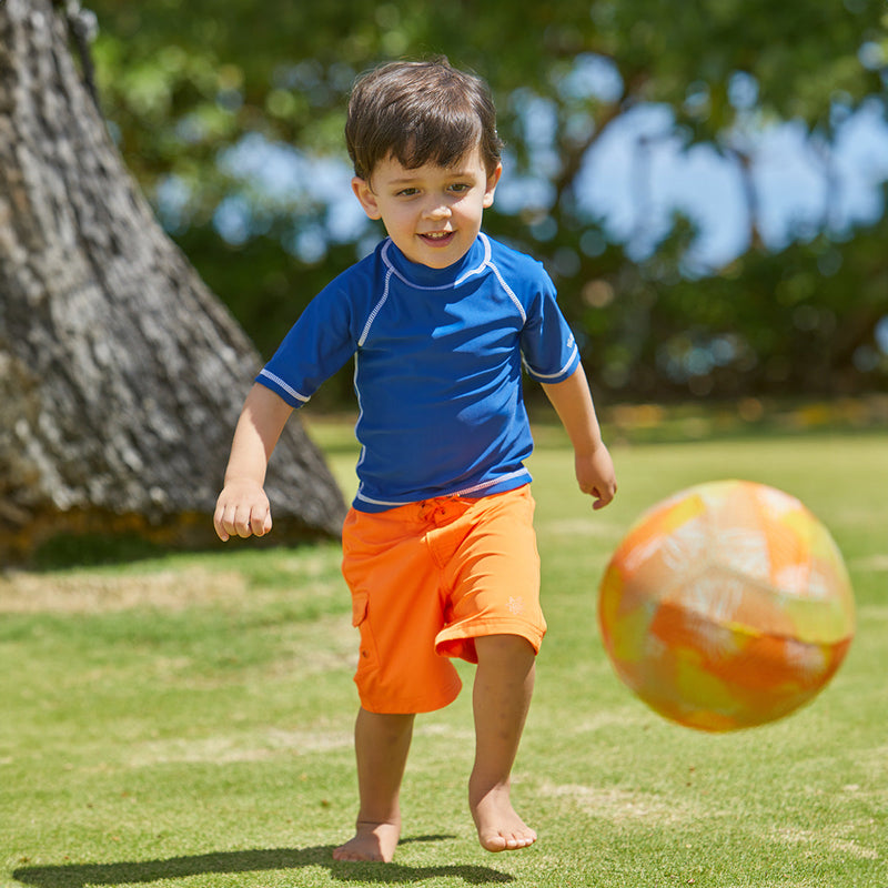 Young Boy Playing in the Sun in the Boy's Classic Board Shorts in Orange|orange