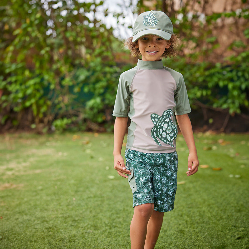 boy in racer stripe board shorts|turtle-cove