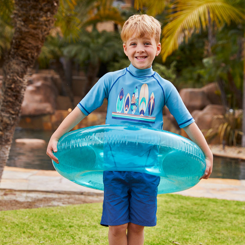 Boy in UV Skinz's boys beach shorts in washed navy|washed-navy