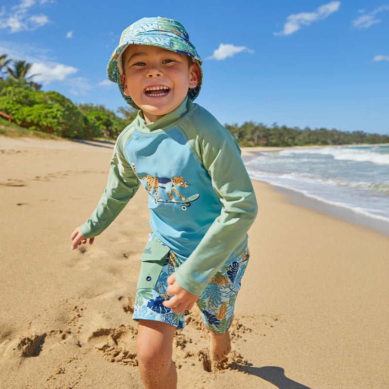 Little boy wearing UV Skinz's boy's long sleeve active swim shirt in sage cool cat|sage-cool-cat