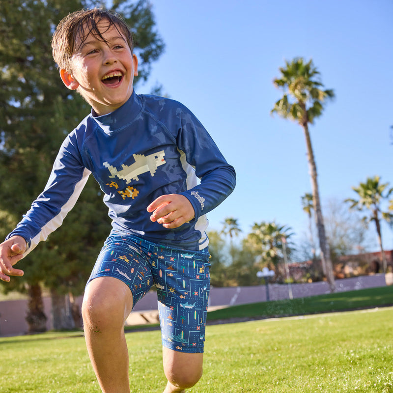 boy running in grass in swim and play jammerz|game-on