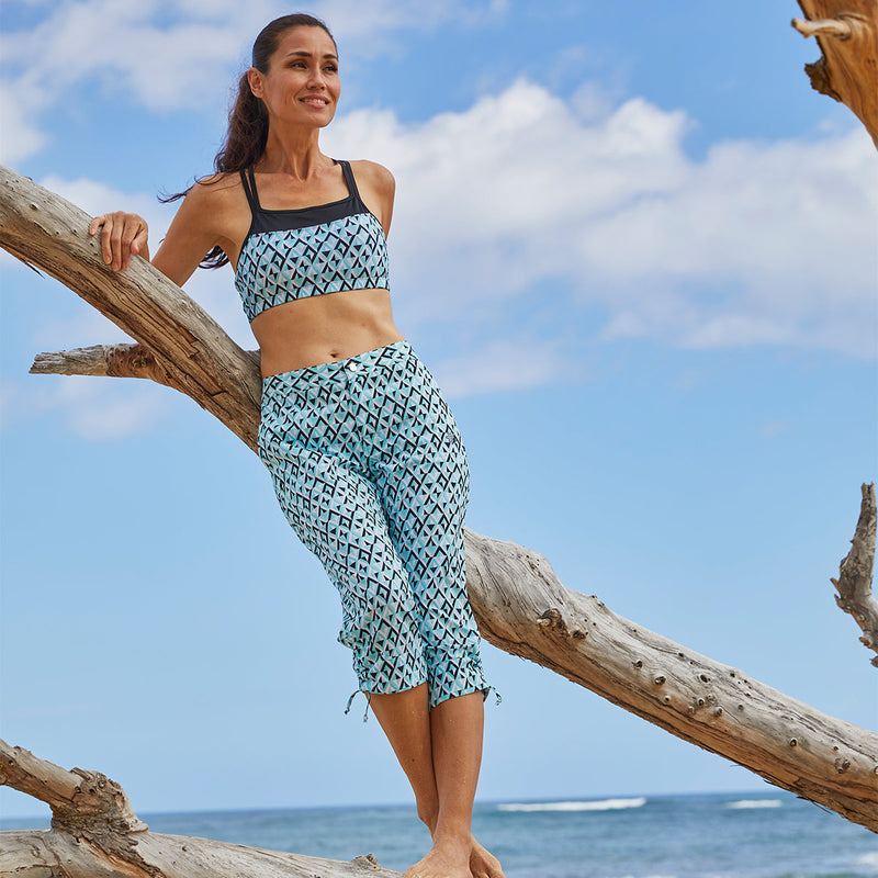 Woman on the Beach Wearing UV Skinz's Women's Beach Capris in Black Jewels|black-jewels