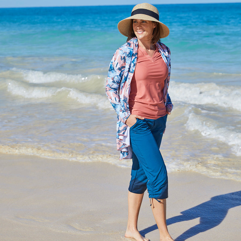 Woman Wearing UV Skinz's Women's V-Neck Sun & Swim Shirt While Wading in the Ocean|canyon