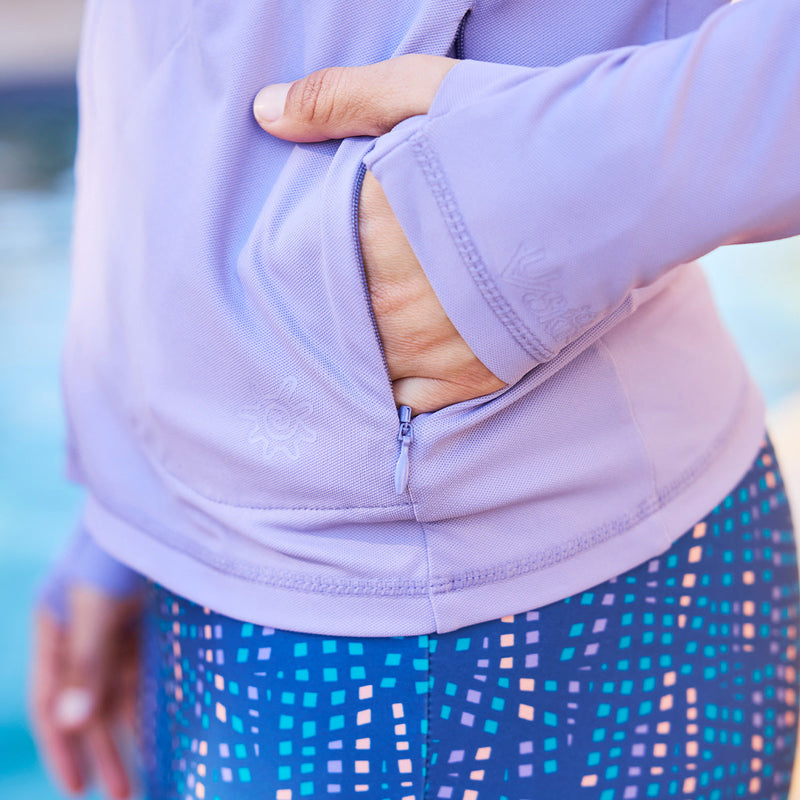 close up of woman hand in pocket of hooded water jacket|daybreak