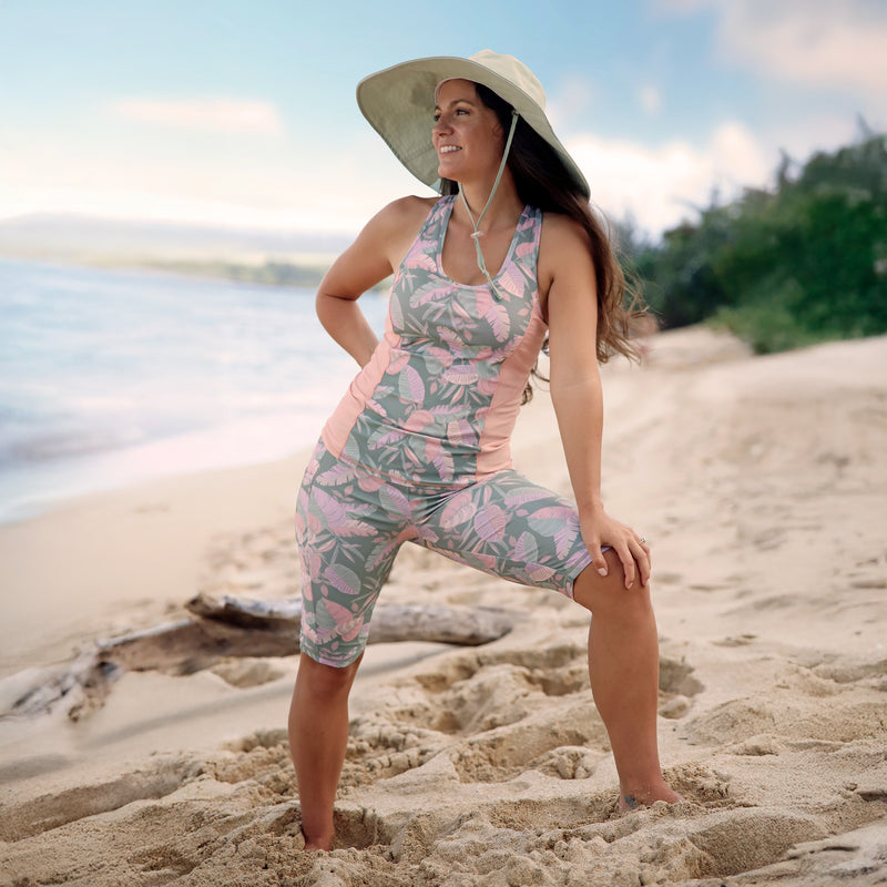 woman posing on the beach in racerback swim tank in lily pad leavescape|lily-pad-leavescape