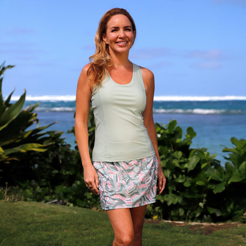 woman posing in racerback swim tank in frosty green|frosty-green