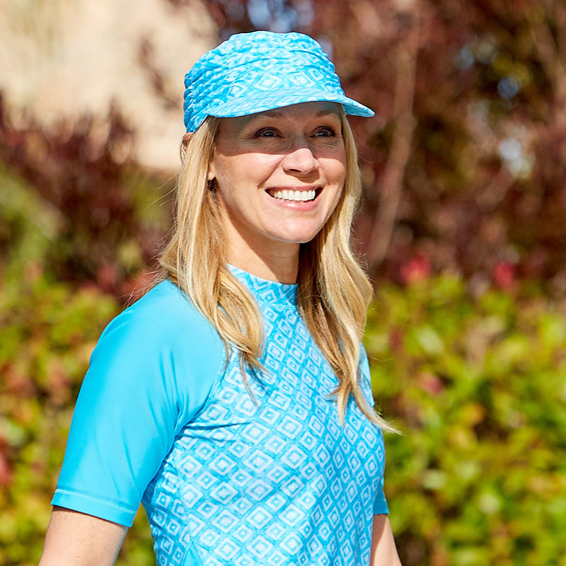 Woman wearing UV Skinz's women's swim cap in aqua diamoond|aqua-diamond