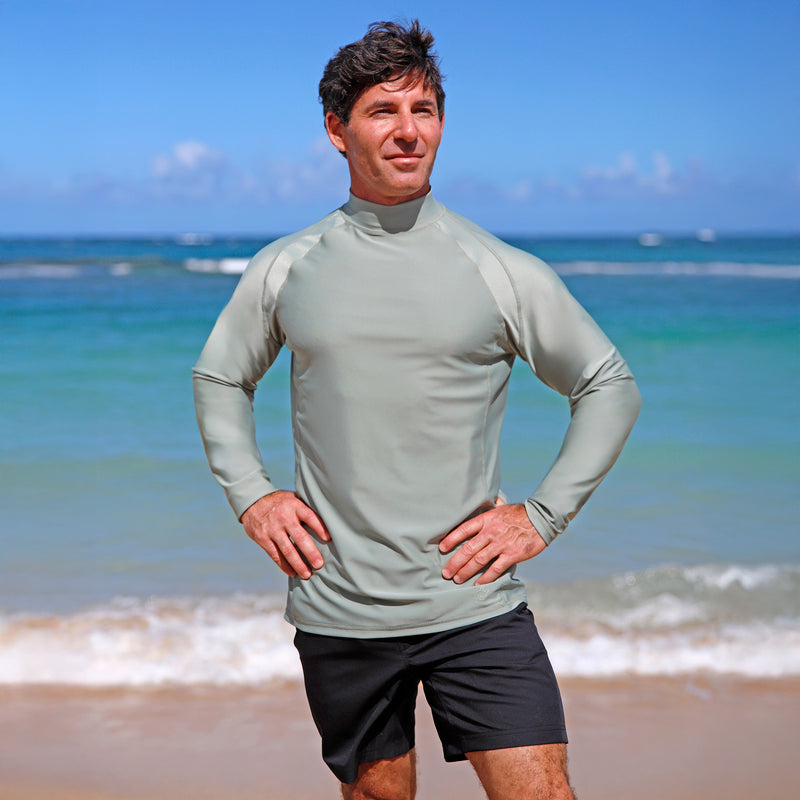 man posing by beach in black adventure shorts|black