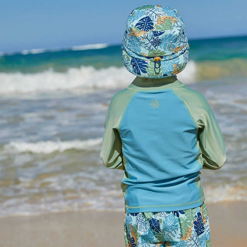 Little boy wearing UV Skinz's boy's long sleeve active swim shirt in sage cool cat|sage-cool-cat