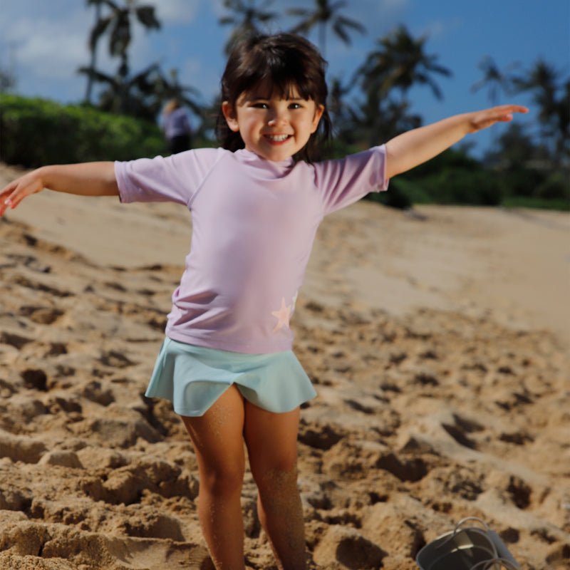 girl playing on the beach in dewdrop flounce skirt|dusty-pink