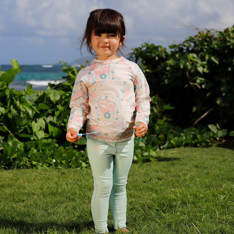 girl on the grass with bubbles in kids long sleeve crew sunny swim shirt in secret garden|secret-garden