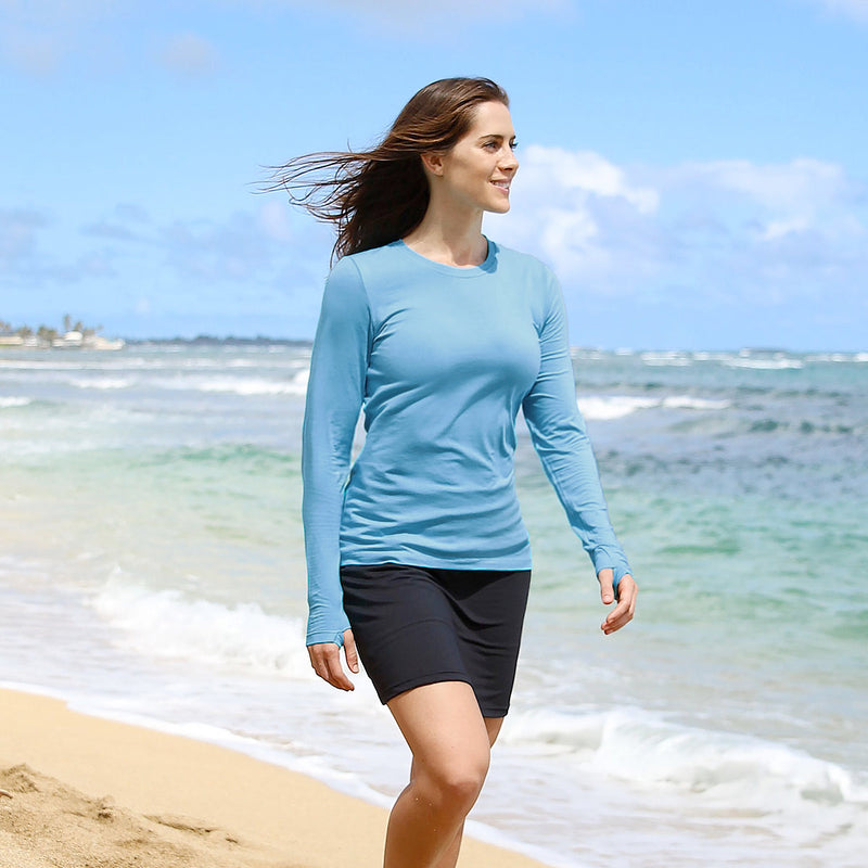 Woman on the Beach in UV Skinz's Women's Long Sleeve Everyday Tee in Scuba Blue|scuba-blue