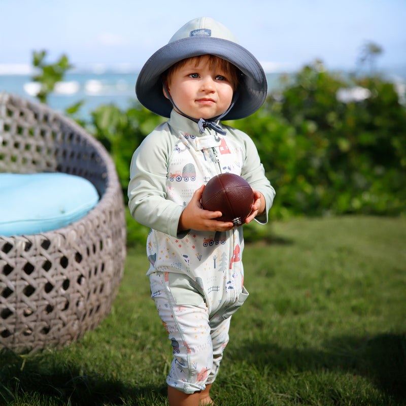 baby boy in grass in on the farm|on-the-farm