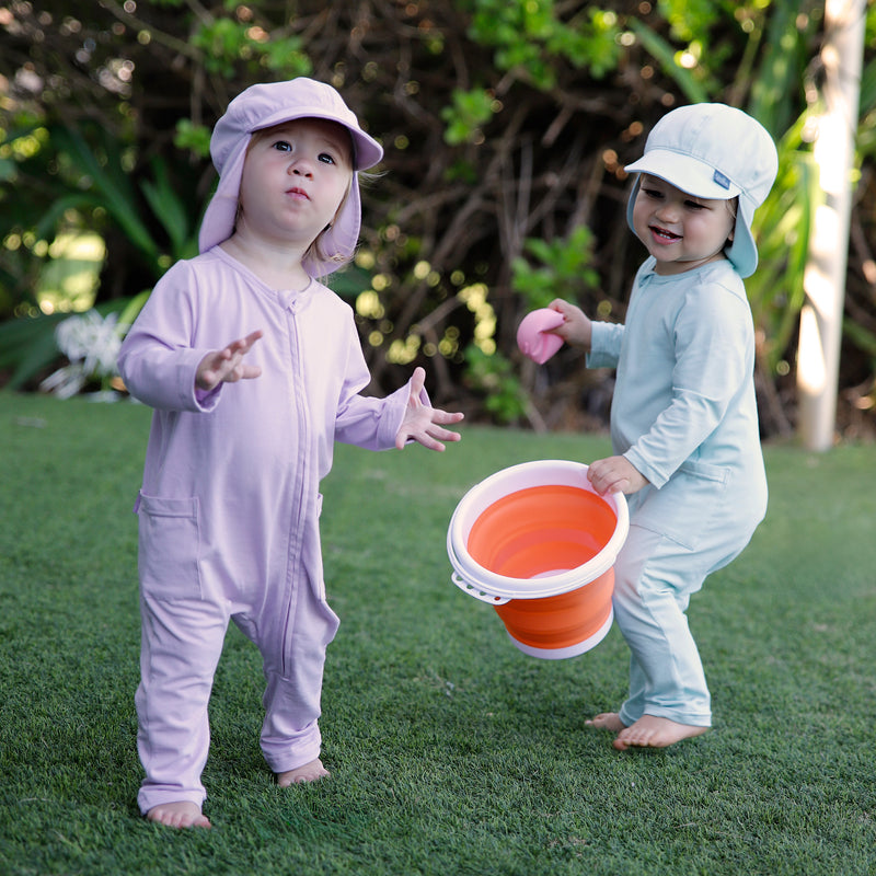 babies in grass in long sleeve everyday rompers in lotus and dewdrop|lotus