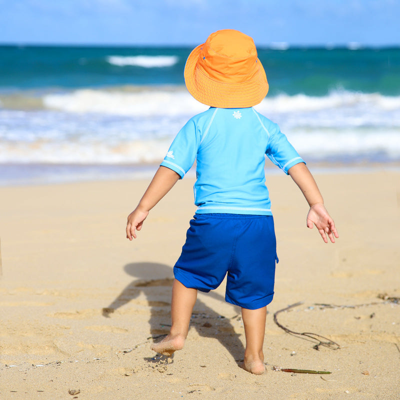 Little boy wearing the boy's bucket hat in royal orange|royal-orange